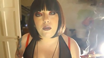 Fat Domme Tina Smokes A Filterless Cigarette While Holding A Lighter